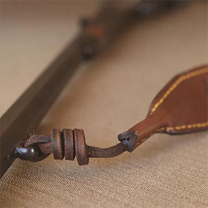 leather straps, rifle slings, yellow stitching